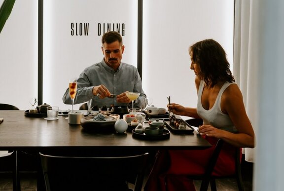 Man and woman sitting a table eating a meal.