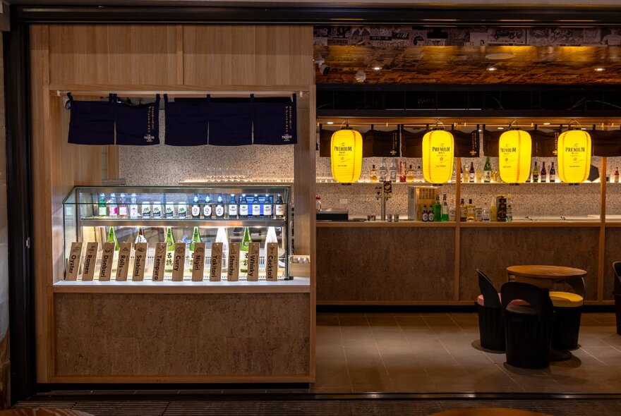 Takeaway sushi cabinet at a Japanese bar, with wooden surround.