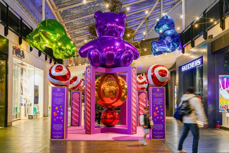 A festive installation at District Docklands, with large inflatable gummy bears floating above a walk through installation.