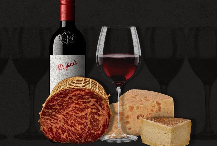 Bresaola, cheese and a bottle of Penfolds shiraz and a glass of poured red wine.  