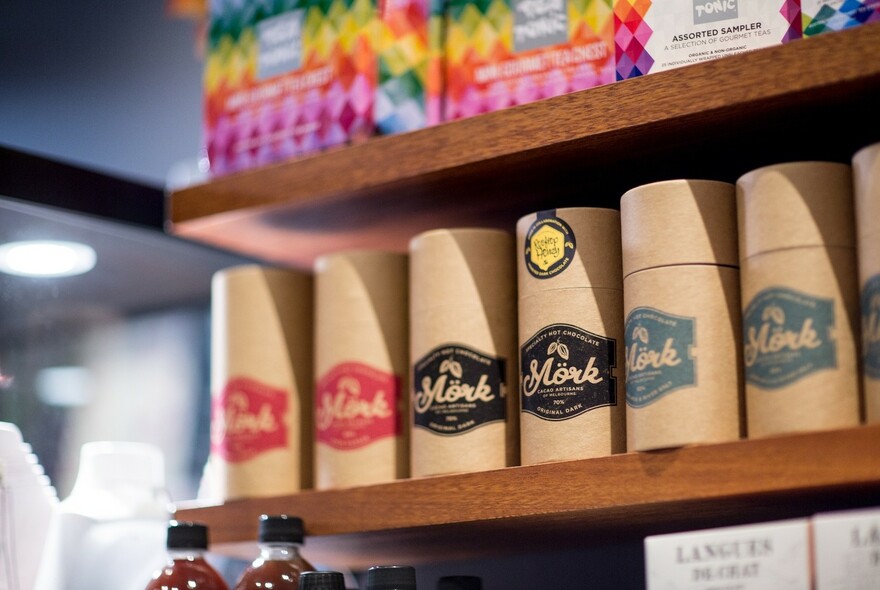 Selection of produce displayed on shelves, including Mork chocolate.