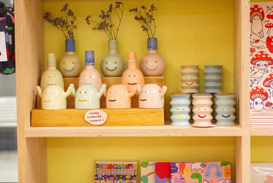 Shelving and yellow walls in a shop that sells cute knickknacks. 