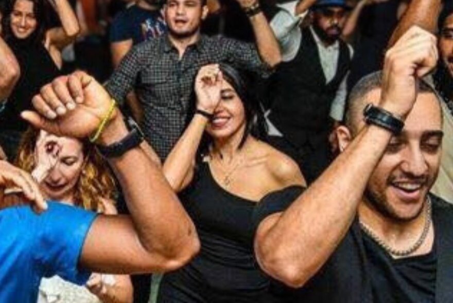 A crowd of people dancing to Cuban music.