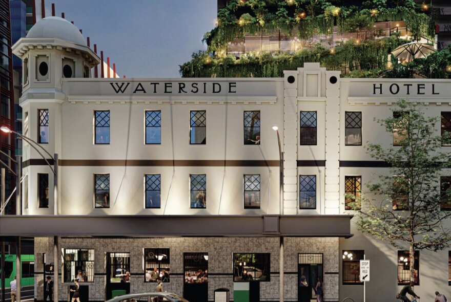 The external facade of the Waterside Hotel, with a vertical garden on the building behind it.