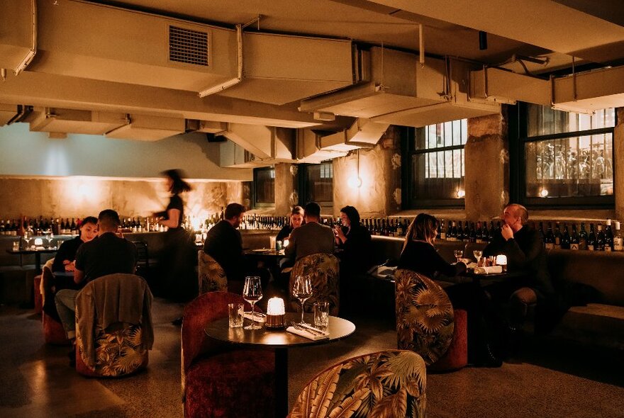 Dimly-lit wine bar with a low ceiling.