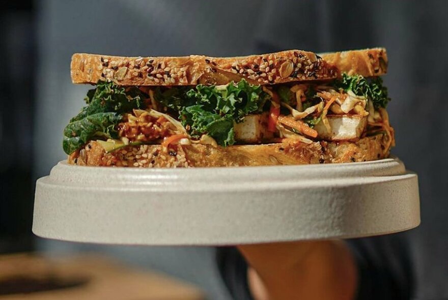 Close-up of a generously filled closed sandwich on a plate.