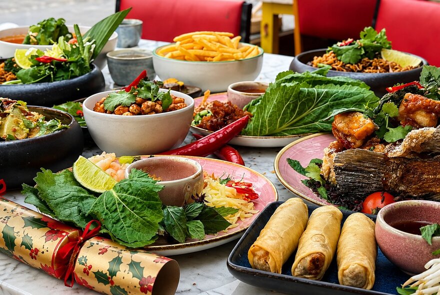 Dishes of food with crackers on a dining table.