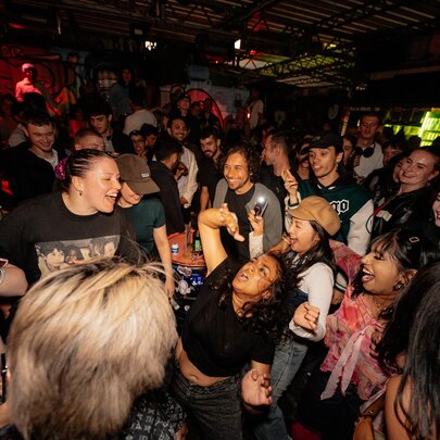 Revellers at a nightclub, dancing.