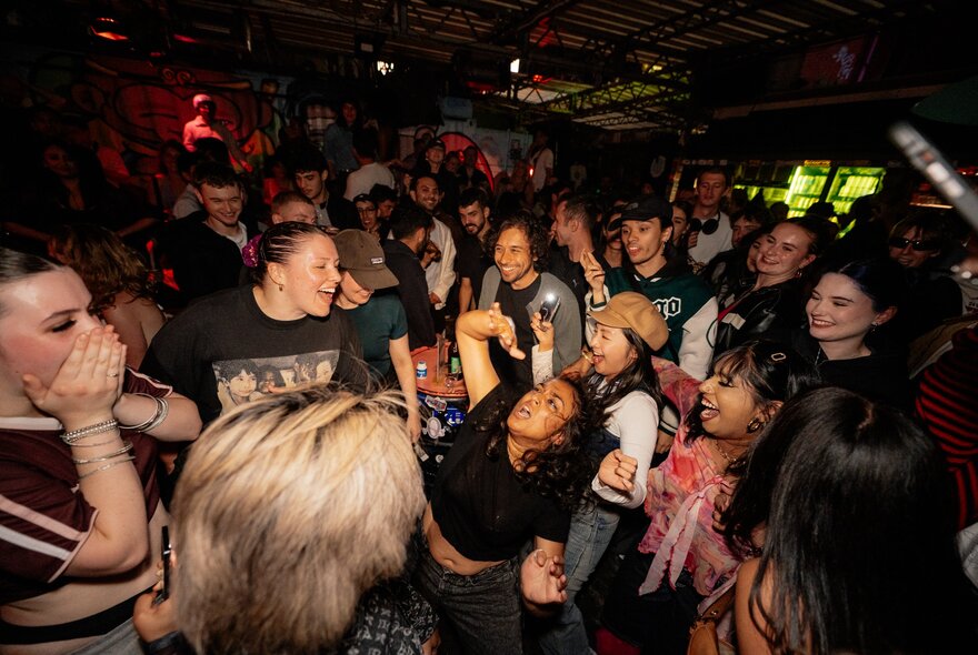 Revellers at a nightclub, dancing.