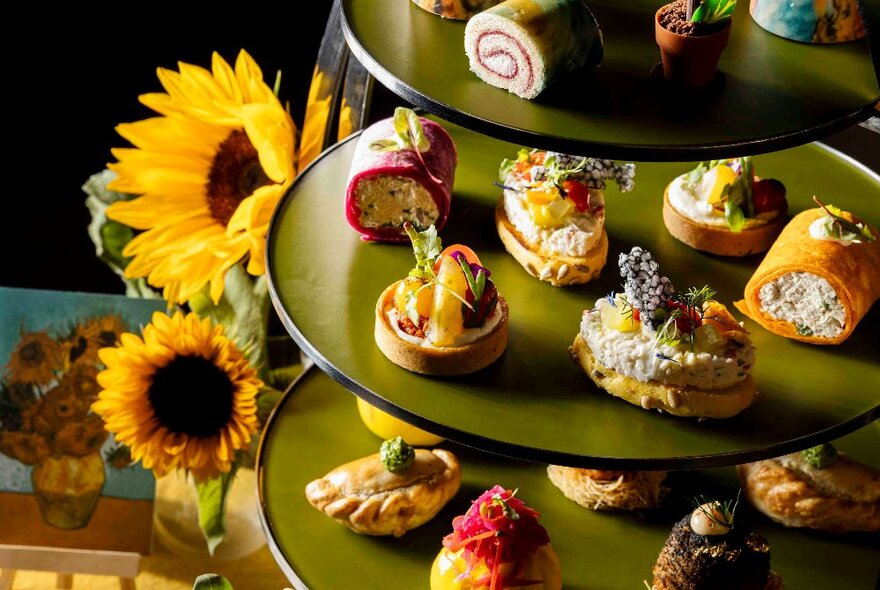 A Van Gogh High Tea with sunflowers and small sweet and savoury bites