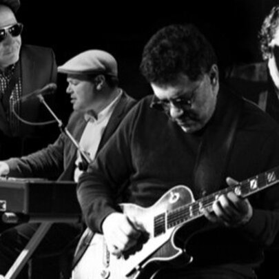 Jazz musicians performing with guitarist, keyboards, saxophone and percussion.