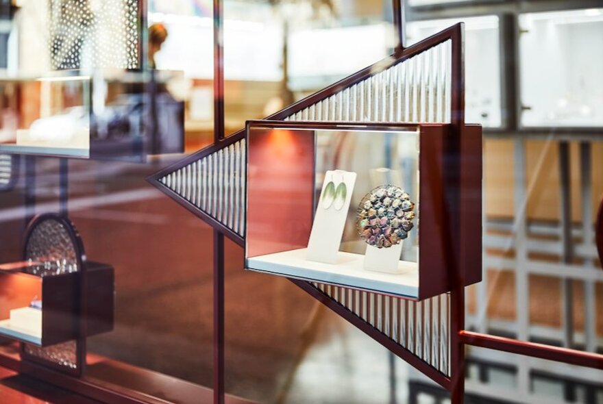 Jewellery on display in a window display as part of an exhibition.