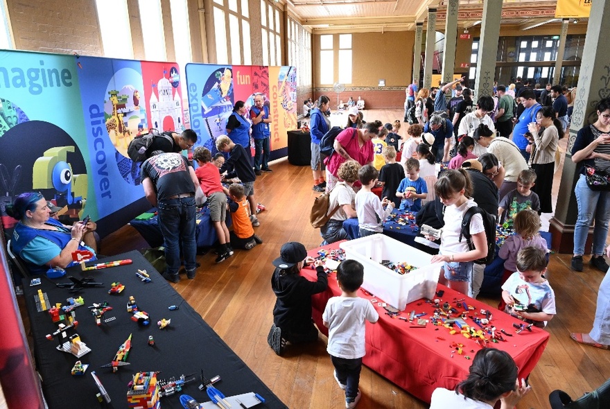 Stalls and crowds of people inside the Royal Exhibition Building.