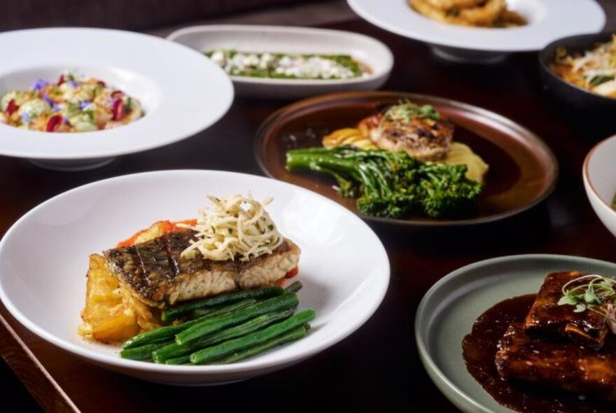 Plates of food arranged on a table in a restaurant.