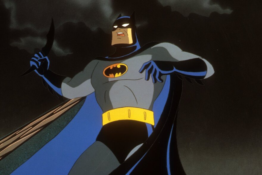 Still from an animation showing Batman in a classic pose with a very dark sky behind him. 