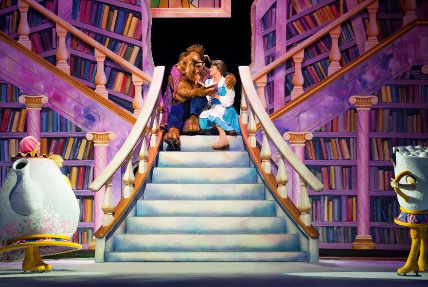 Belle and the Beast, reading books on a staircase in a library during Disney on Ice.