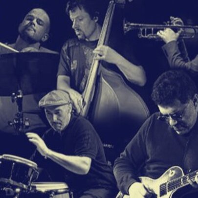 Jazz musicians performing including guitarist, percussion, trumpet and double bass.
