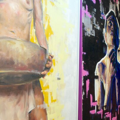 Details of artwork hanging in a gallery. 