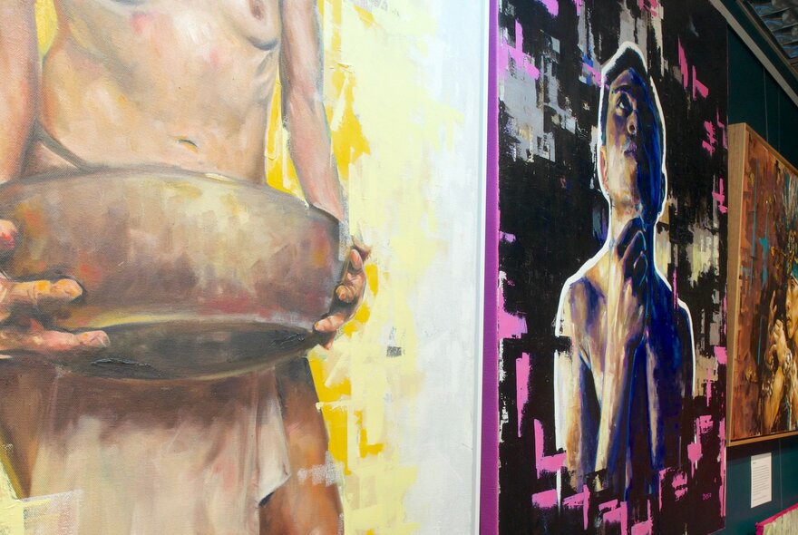 Details of artwork hanging in a gallery. 