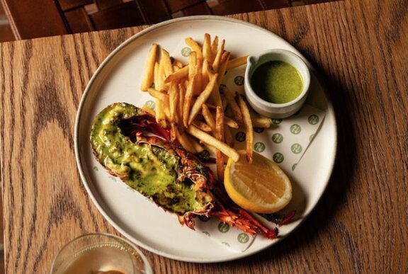 Lobster with green sauce and fries.