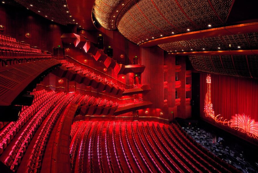 Interior of the the State Theatre Melbourne with empty theatre space and red lighting. 