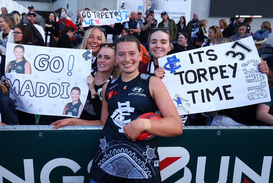 Carlton fans and player by the stands.
