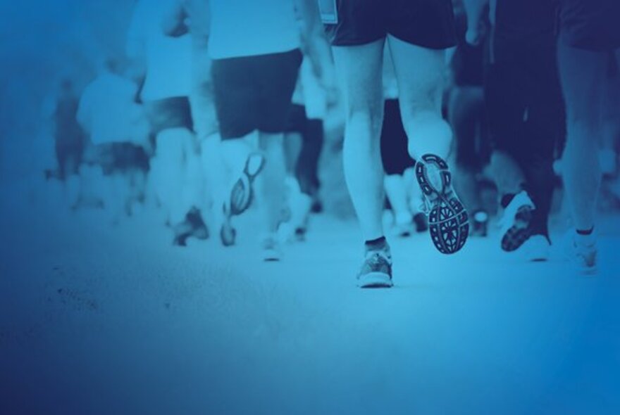 A parade of legs wearing trainers in a blue background.