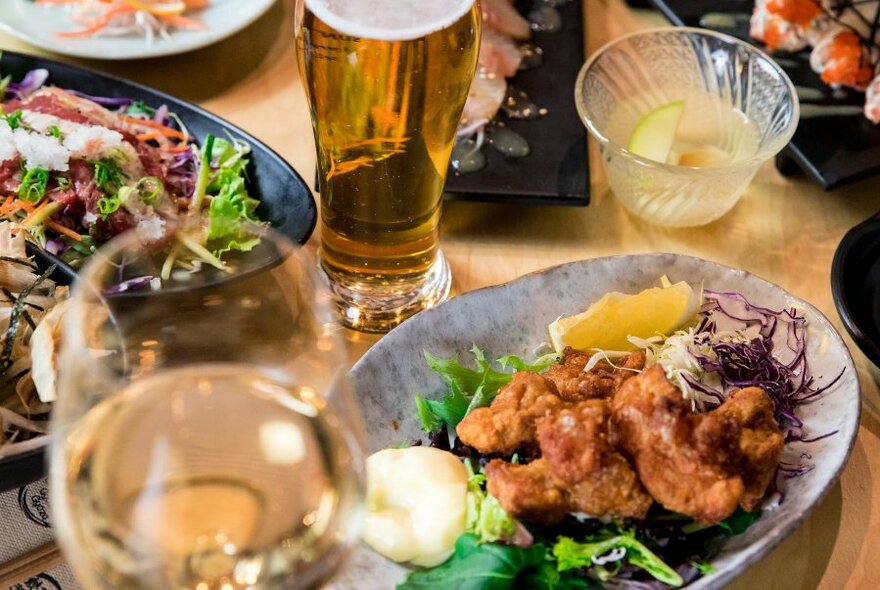 Plate of Japanese food and a beer.