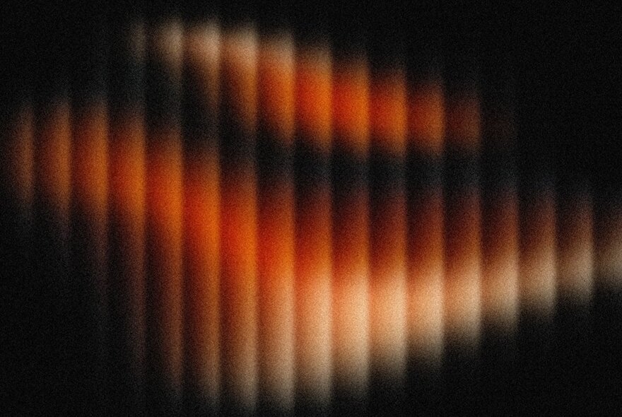 Illuminated panels  with shades of red on a black background. 