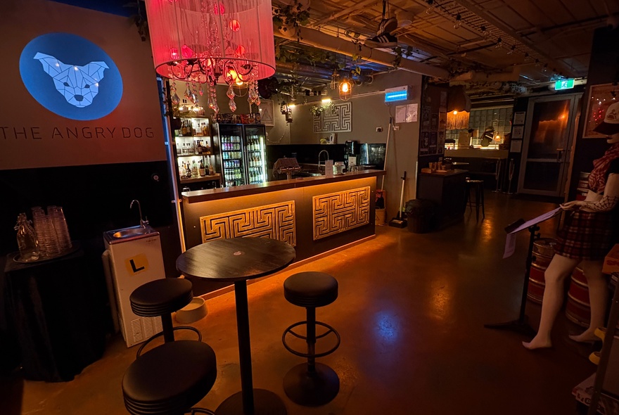 Venue with bar area, stool seating and lantern lighting.