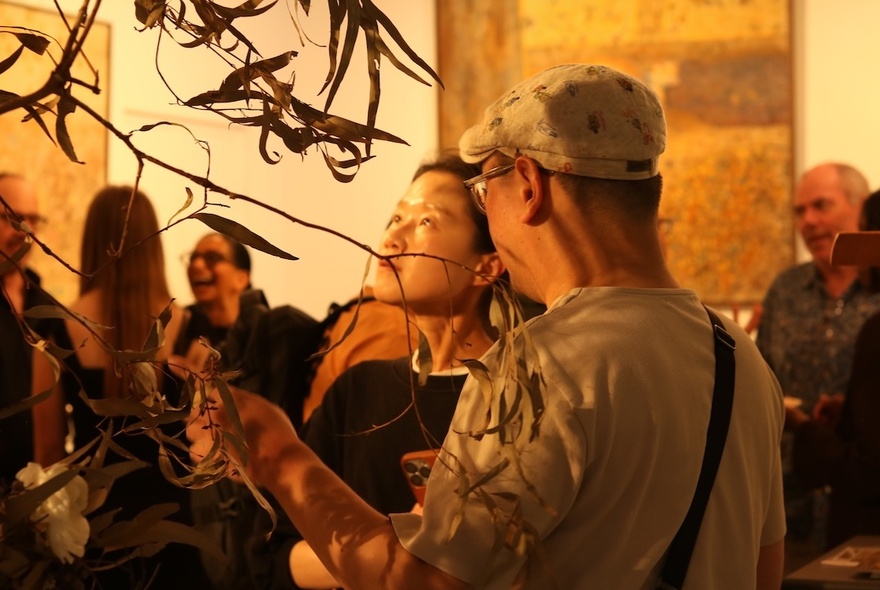 People looking at artworks in a gallery space.