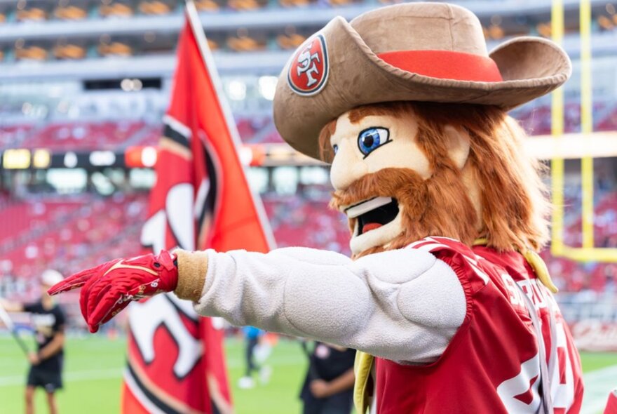 49ers mascot with flag, red beard and hat.