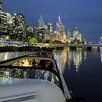 A scenic night cruise on the Yarra River, Melbourne, showcasing the city's skyline.