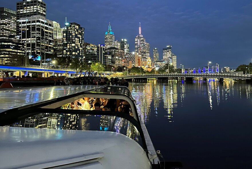 A scenic night cruise on the Yarra River, Melbourne, showcasing the city's skyline.