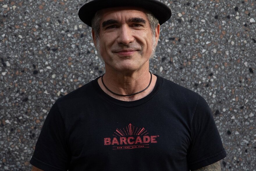 Singer Jack Jones in a black t-shirt and hat, smliling.