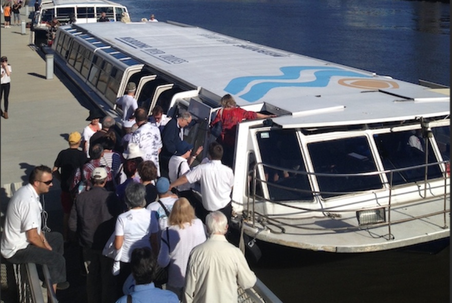 Passengers boarding a cruise boat on the Yarra River.