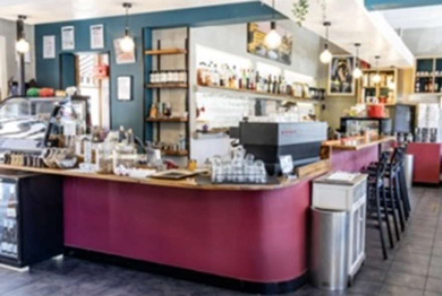 An indoor magenta coloured bar and counter. 