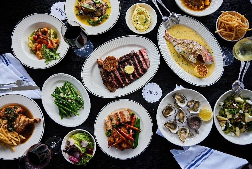 Looking down at a table laden with plates of food.