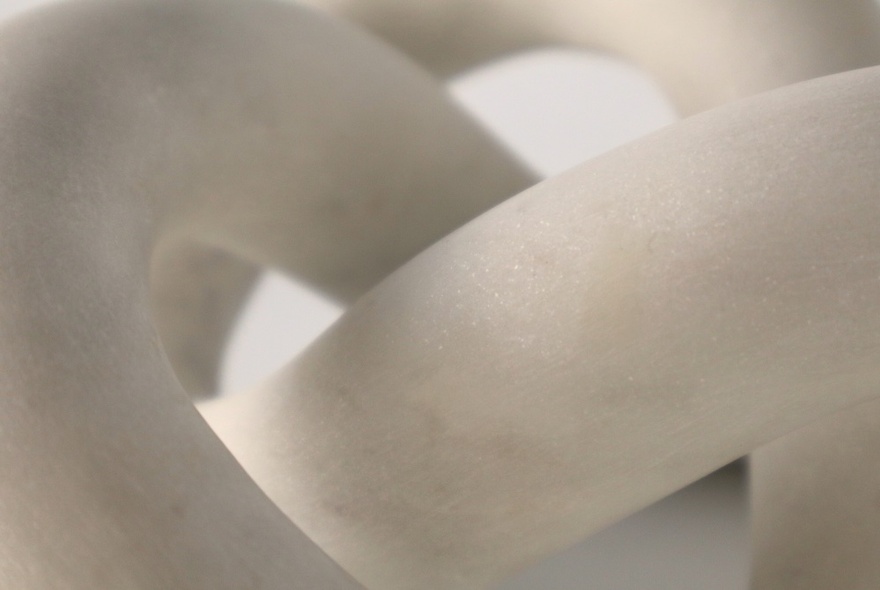 Detail of abstract, curved white sculpture.