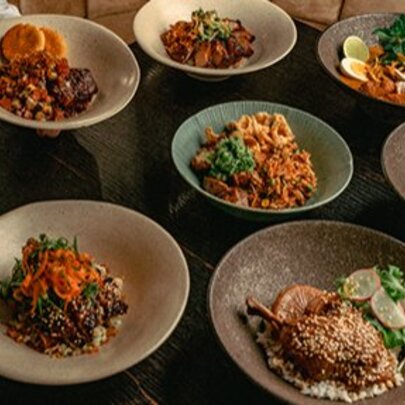 A table set with various dishes in bowls.