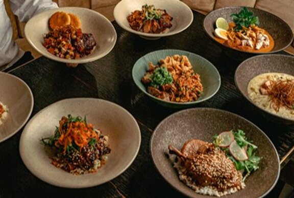A table set with various dishes in bowls.
