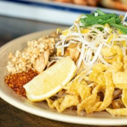 A Thai meal of stir fried meat with fried noodles.