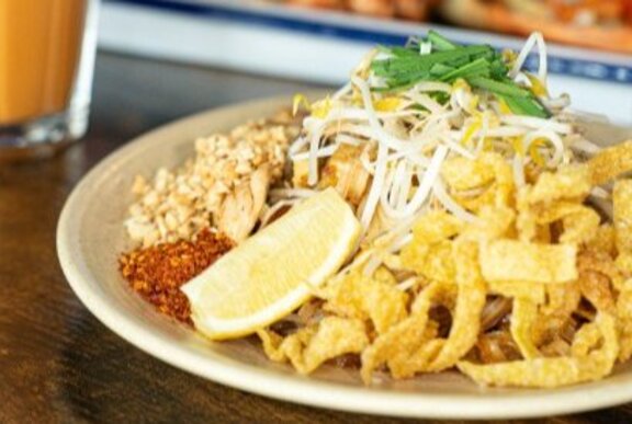A Thai meal of stir fried meat with fried noodles.
