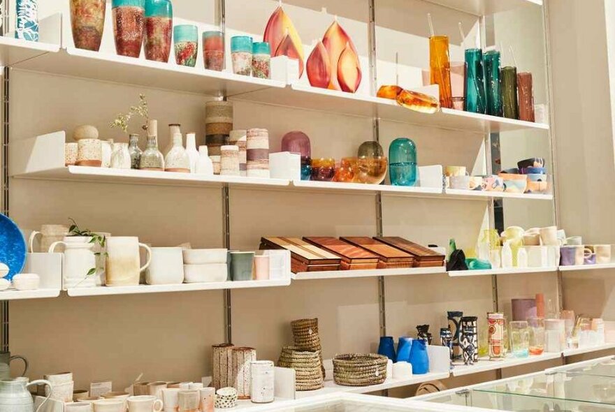 A shelf filled with craft and crockery items.