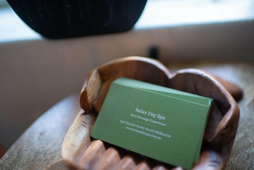 Business card of Relax Day Spa on the counter.