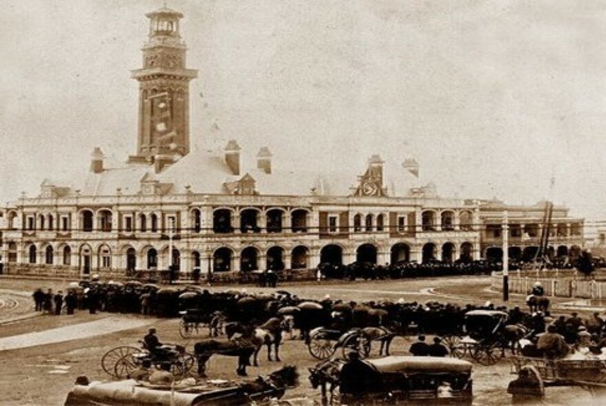 Old sepia photo of horse-drawn fire vehicles.