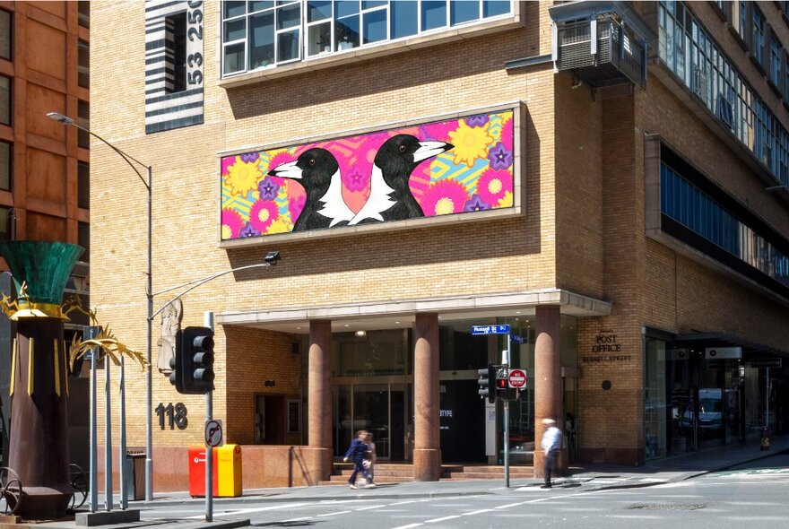 Hero apartment building facade with brightly coloured public artwork above modernist columned porch area, featuring magpies and flora.