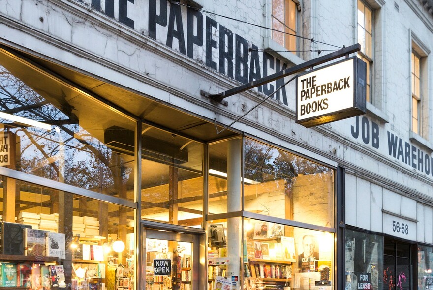 Exterior of The Paperback Bookshop at twilight.