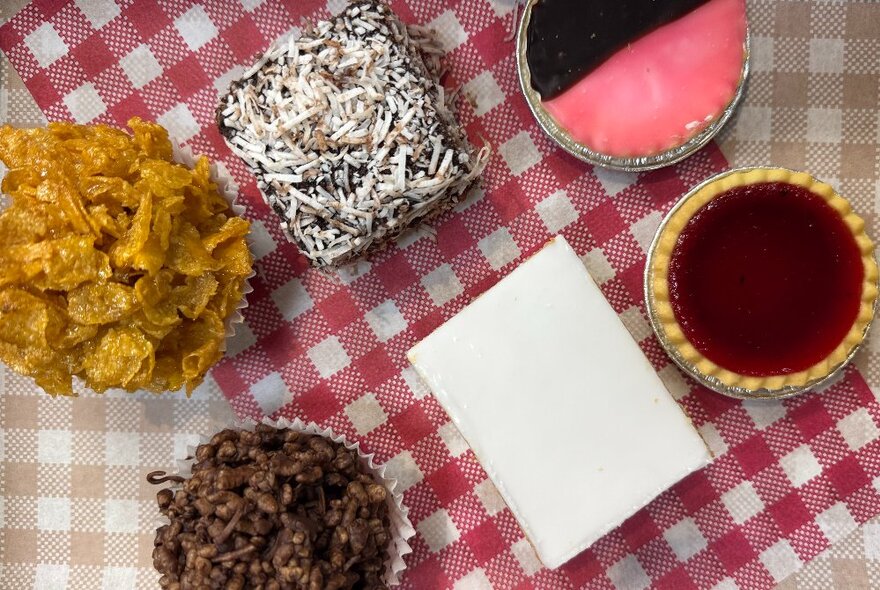 A selection of bakery treats displayed on a red and white gingham napkin.