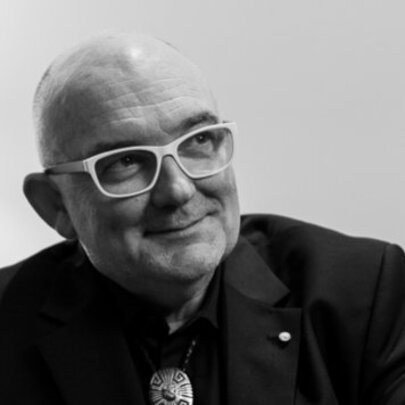 A black and white image of James Morrison looking bemused wearing white glasses. 